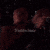 a blurry picture of a person 's face with a red shirt on