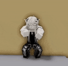 a black and white cartoon character is sitting on the floor with his arms crossed .