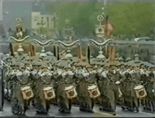 a large group of soldiers marching down a street