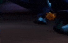 a dragon is laying on the ground with its wings outstretched .
