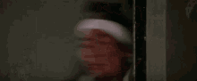 a blurry picture of a person holding a knife in a room .