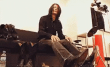 a man is sitting on a couch with his legs crossed and his feet up .