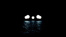 three white circles in the middle of a dark ocean