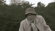 a man wearing a hat and glasses looks shocked