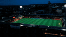 an aerial view of a soccer field at night with a sign that says ' bwin ' on it