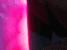 a close up of a pink light coming out of a bottle .