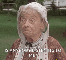 an elderly woman wearing glasses and a white hat is asking if anyone is listening to her