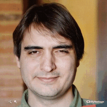 a close up of a man 's face with myheritage written on the bottom