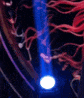 a blurry picture of a person with red hair and a blue light coming out of it