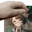 a hand is holding a piece of paper with a picture of a girl in a hat on it .