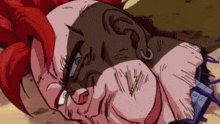 a man with red hair and a tattoo on his face is laying on the ground .