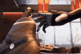 a robotic hand is reaching out to touch another robotic hand .