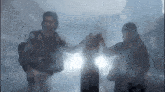 a man is holding a woman 's hand in a foggy room .