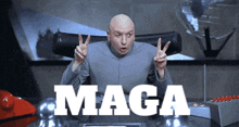 a bald man is giving a peace sign in front of a sign that says maga