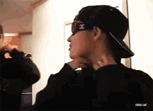 a man wearing sunglasses and a hat with the letter j on it