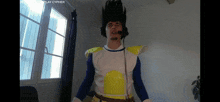 a man in a dragon ball z costume is wearing a microphone and headphones