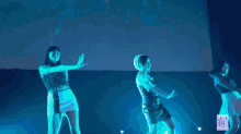 three girls are dancing on a stage with the number 18 on the bottom right