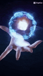 a person 's hand is holding a glowing sphere that says capcut on the bottom right