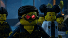 a group of lego figures are standing in a line and one of them has red eyes