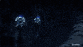 a robot is flying through the air with a blue light coming out of it 's mouth .