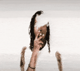 a man with dreadlocks is smoking a cigarette with smoke coming out of his nose