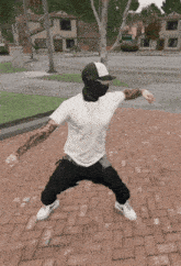 a man in a white shirt and black pants is standing on a brick sidewalk with his arms outstretched