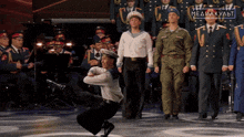 a group of men in military uniforms are standing in front of a sign that says mediakulbit