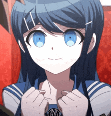 a close up of a girl with blue eyes and a ns logo on her shirt