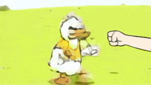 a cartoon duck is walking in a field with a fist in front of it .
