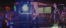 a group of women are standing in a room with a blurred background