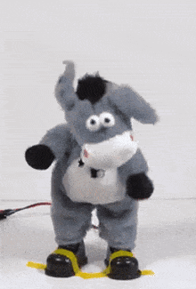 a stuffed donkey with a leash around its neck dancing