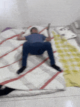 a man laying on a bed holding a remote