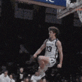 a basketball player wearing a butler jersey is jumping in the air
