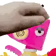 a person is holding a pink cartoon character 's head with their hand .