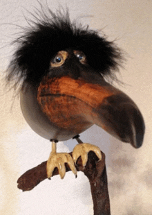a statue of a bird with feathers on its head