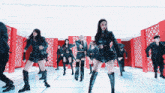 a group of women are dancing together in a room
