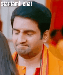 a close up of a man 's face with the words star tamil chat written on the bottom