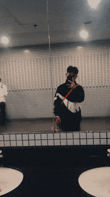 a man is taking a picture of himself in a bathroom mirror