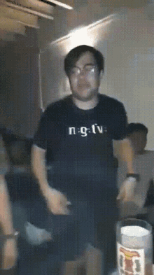 a man wearing a shirt that says n : g : tv is dancing