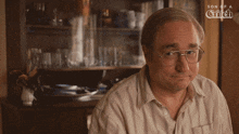 a man with glasses is talking to a woman in a son of a witch ad