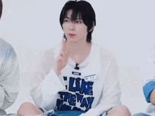 a young man wearing a white shirt that says like the way