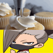 a close up of a cupcake with frosting and a drawing of a person with a mask on