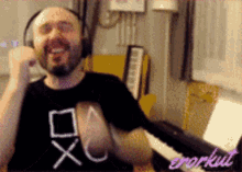 a man wearing headphones and a t-shirt that says xc on it