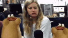 a woman making a funny face in front of a microphone