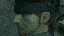 a close up of a man 's face with a headband on