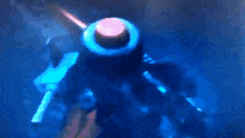 a blurry picture of a person holding a gun in the dark