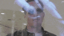a man 's face is visible through a glass door .