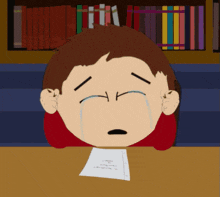 a cartoon character is crying while sitting at a table