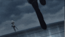 a silhouette of a person standing on a roof with a gun