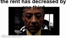 a man in a suit and tie is sitting in front of a window with glasses on .